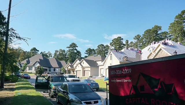 Capital Roofing Solutions trailer at job site